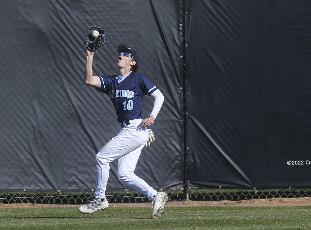 Corona del Mar centerfielder Brady Gadol makes a deep catch for an out at the fence.