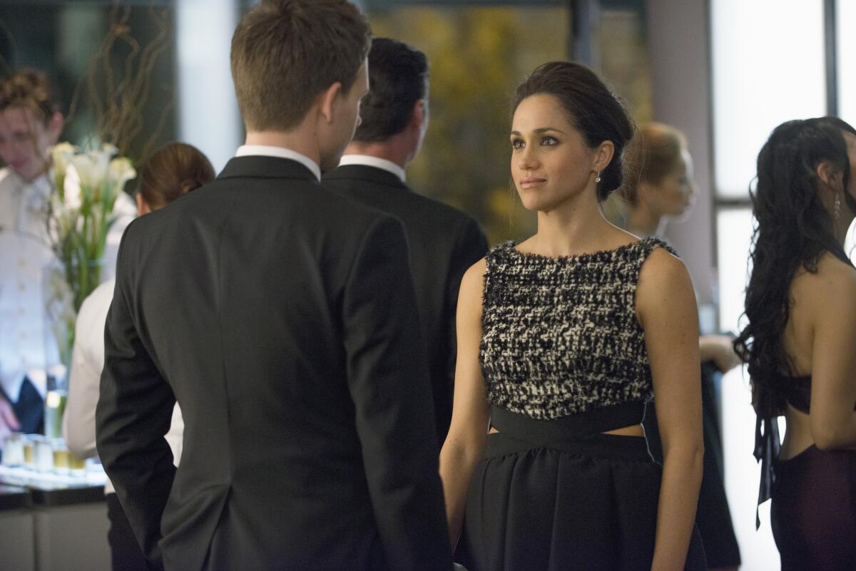 A man and a woman interact a scene in the series "Suits." 