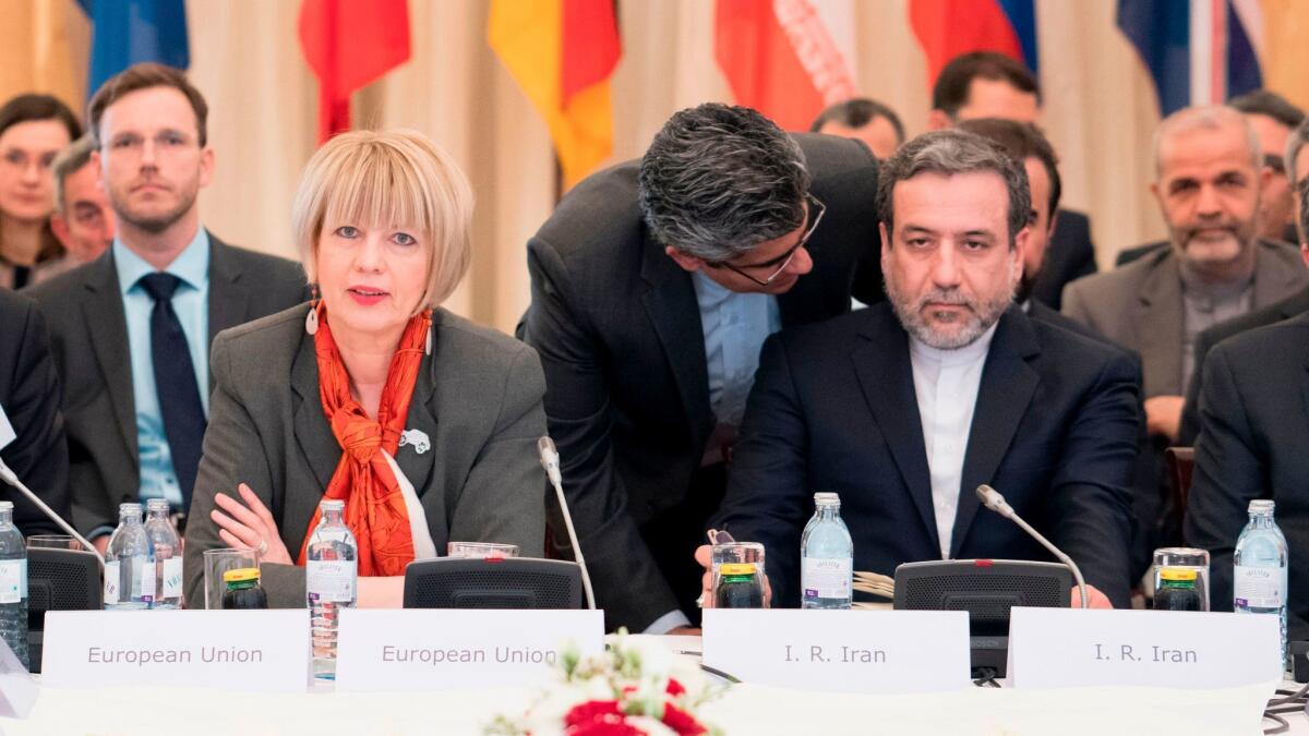 EU senior diplomat Helga Schmid, left, Iranian Deputy Foreign Minister Abbas Araghchi and senior diplomats from six other major powers meet in Vienna on April 25, 2017, to review adherence to a 2015 nuclear deal.