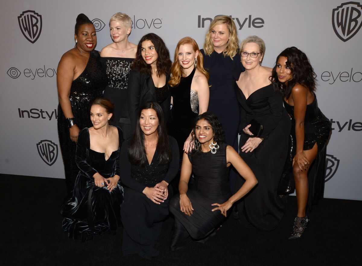 From top left, Rosa Clemente, Michelle Williams, America Ferrera, Jessica Chastain, Amy Poehler, Meryl Streep and Kerry Washington pose for a photo with Natalie Portman, Ai-jen Poo and Saru Jayaraman at the InStyle and Warner Bros. Golden Globe after-party on Sunday.