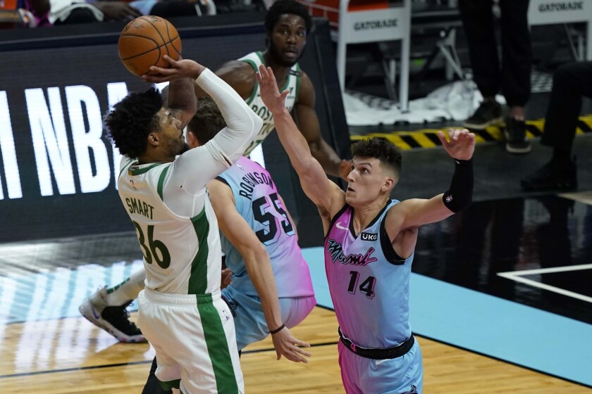 Boston Celtics guard Marcus Smart (36) drives to the basket as Miami Heat guard Tyler Herro (14) defends during the first half of an NBA basketball game, Wednesday, Jan. 6, 2021, in Miami. (AP Photo/Marta Lavandier)