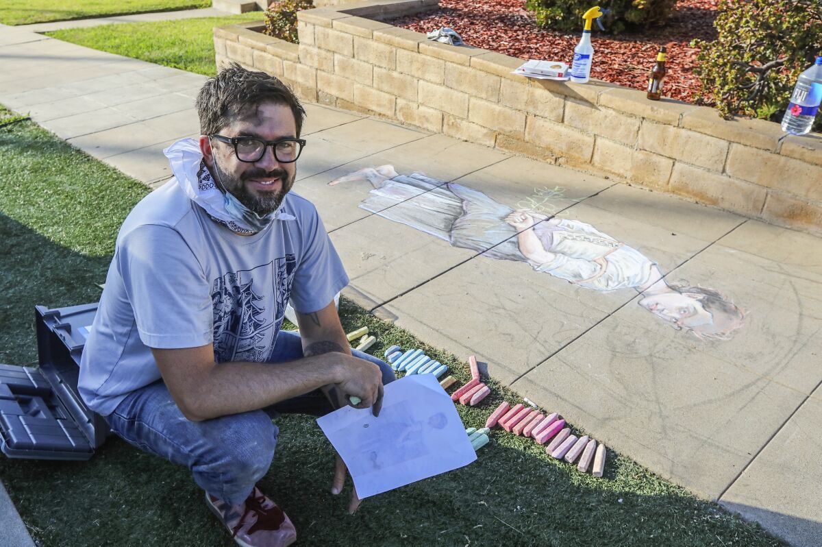 OB resident Erick Toussaint works on a one of his chalk art creations