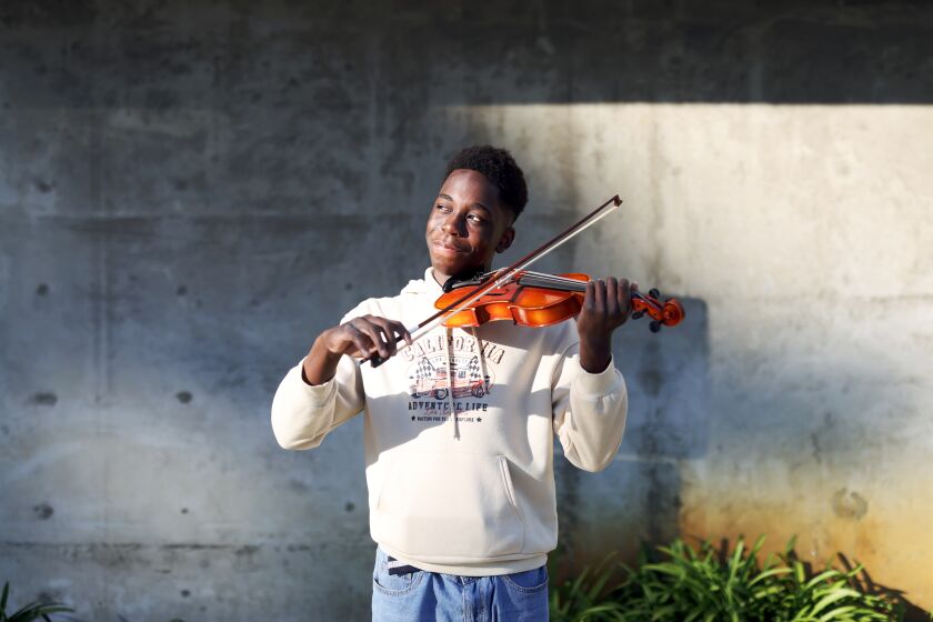 LOS ANGELES, CA - FEBRUARY 06: Kevon Fortune, 16, stands for a portrait with his violin before practice.