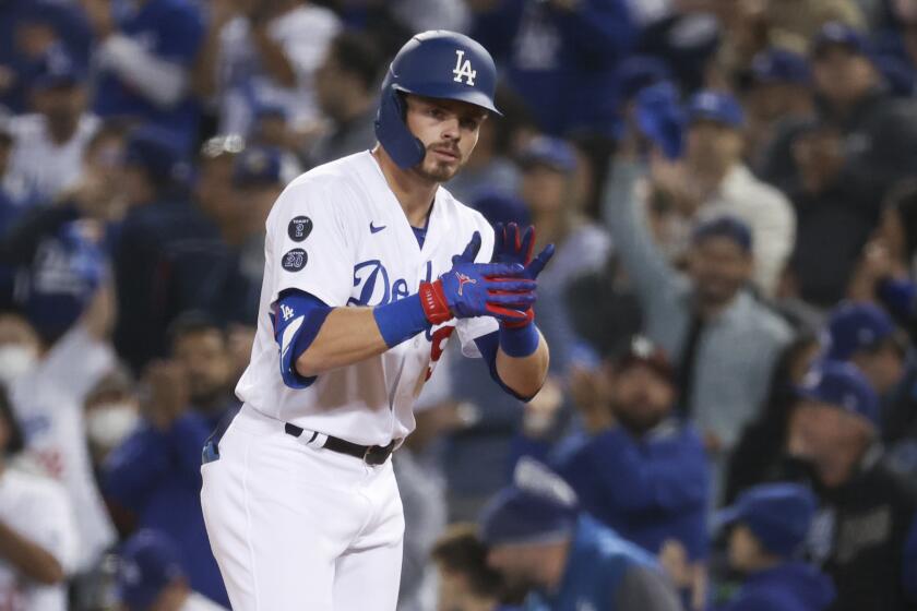 Los Angeles, CA - October 12: Los Angeles Dodgers' Gavin Lux claps while at first after a single during.