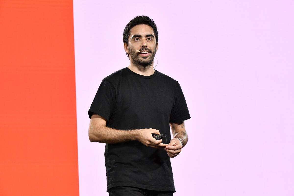 Runway Chief Executive Cristóbal Valenzuela speaks onstage with a headset microphone