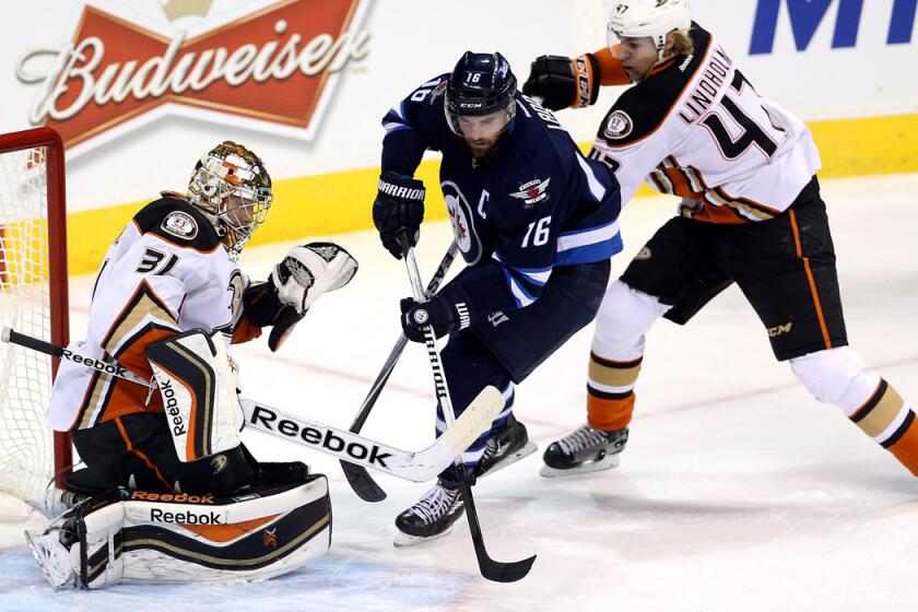 Ducks goaltender Frederik Andersen turns away a shot by Winnipeg's Andrew Ladd in the first period Sunday.