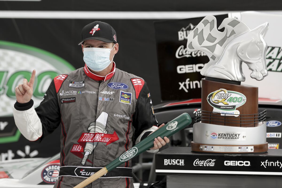 Cole Custer celebrates with the trophy after winning a NASCAR Cup Series race on Sunday in Sparta, Ky.