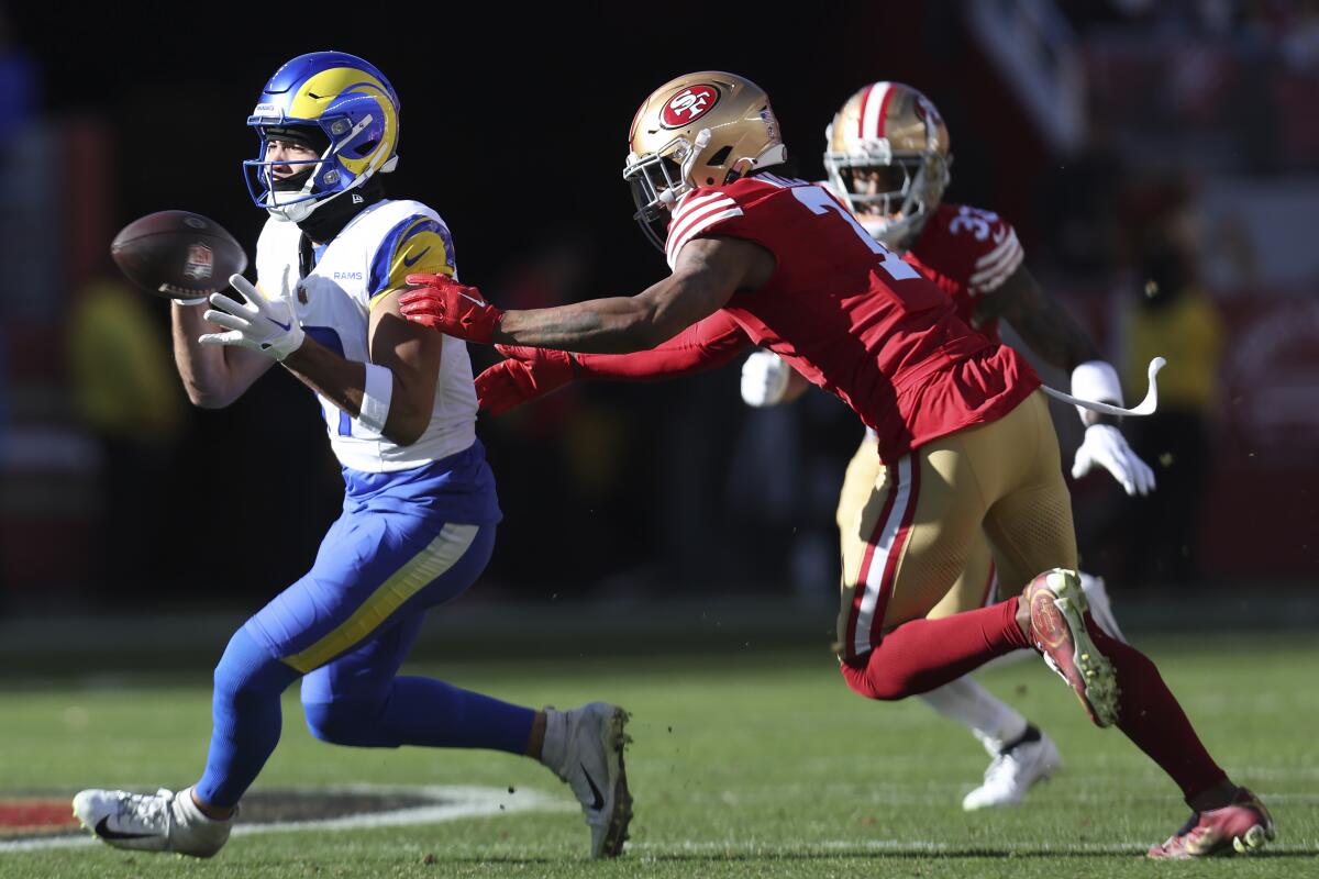 Rams wide receiver Puka Nacua, left, catches a pass in front of San Francisco 49ers cornerback Charvarius Ward.