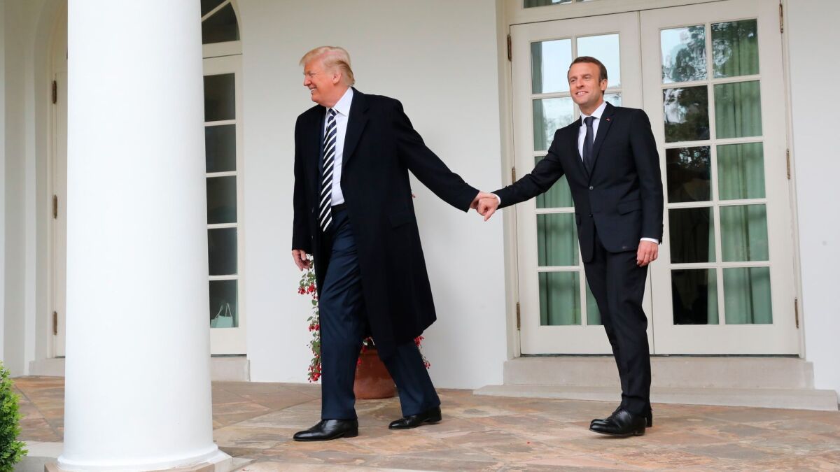President Trump and French President Emmanuel Macron walk to the Oval Office of the White House.