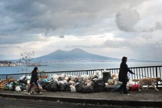 FILE - People walk past uncollected trash in Naples, Italy, on Nov. 22, 2010. The European Court of Human Rights has found Italy violated the human rights of residents living in and around Naples by failing to manage a 15-year garbage and pollution crisis. The verdict announced Thursday, Oct. 19, 2023 is the second major one in recent years finding that Italy’s failure to collect, treat and dispose of tons of waste in the Campania region adversely affected residents’ personal well-being. (AP Photo/Salvatore Laporta, File)