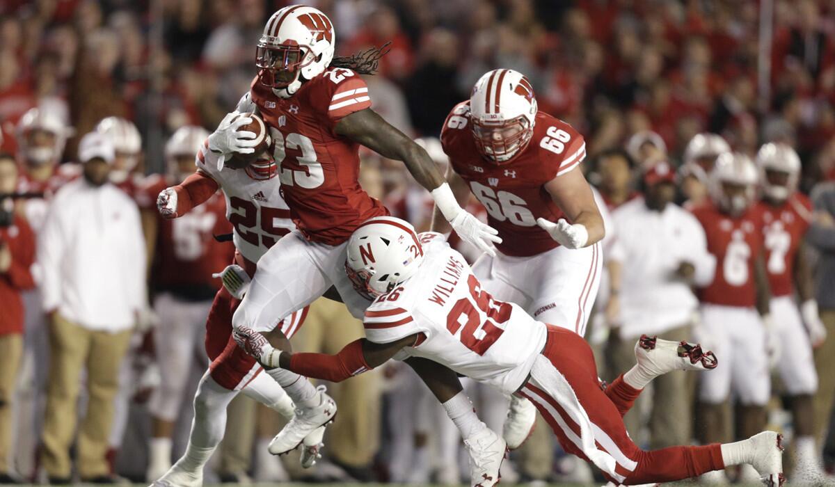 Wisconsin's Dare Ogunbowale (23) runs with the football before getting tackled by Nebraska's Kieron Williams (26) during the third quarter Saturday.