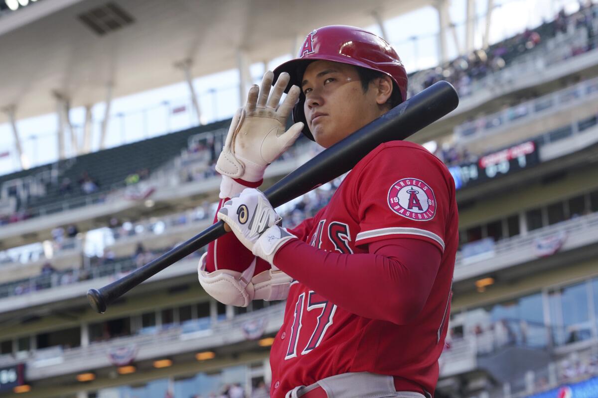 Los Angeles Angels' pitcher Shohei Ohtani (17) waves to fans as he waits on deck to bat in the fourth inning.