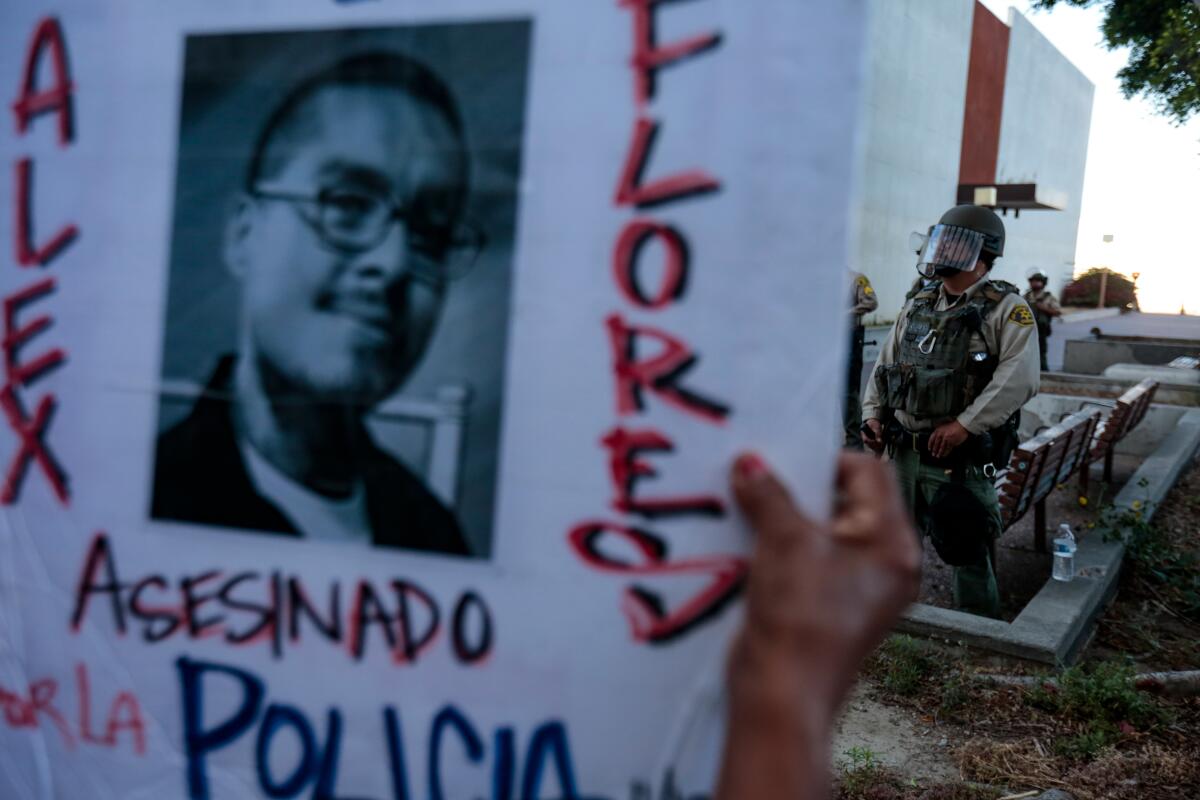 Protesters march outside the L.A. County sheriff's Compton station