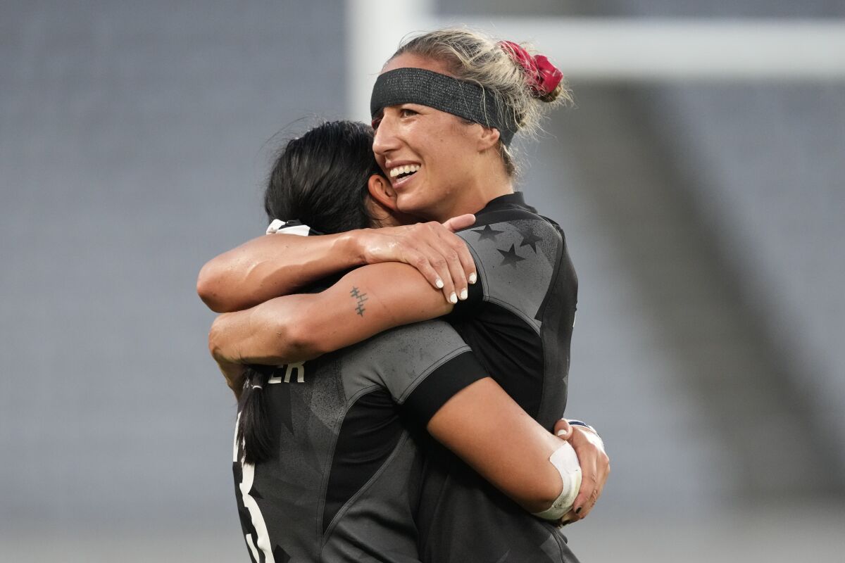 New Zealand's captain Sarah Hirini, right, hugs teammate Stacey Fluhler after winning gold in women's rugby sevens at the 2020 Summer Olympics, Saturday, July 31, 2021 in Tokyo, Japan. (AP Photo/Shuji Kajiyama)