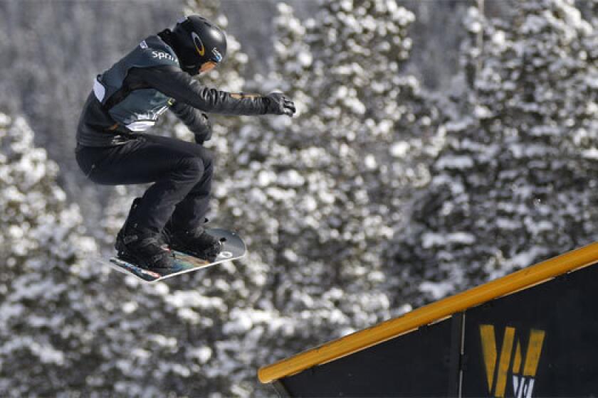 Shaun White slides off a rail during the U.S. Grand Prix slopestyle snowboarding finals on Sunday.