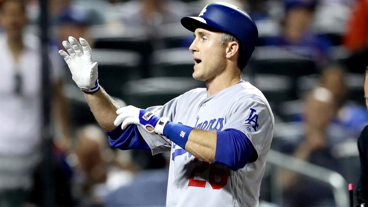 The Dodgers' Chase Utley celebrates after hitting a grand slam home run against the Mets in the seventh inning Saturday.