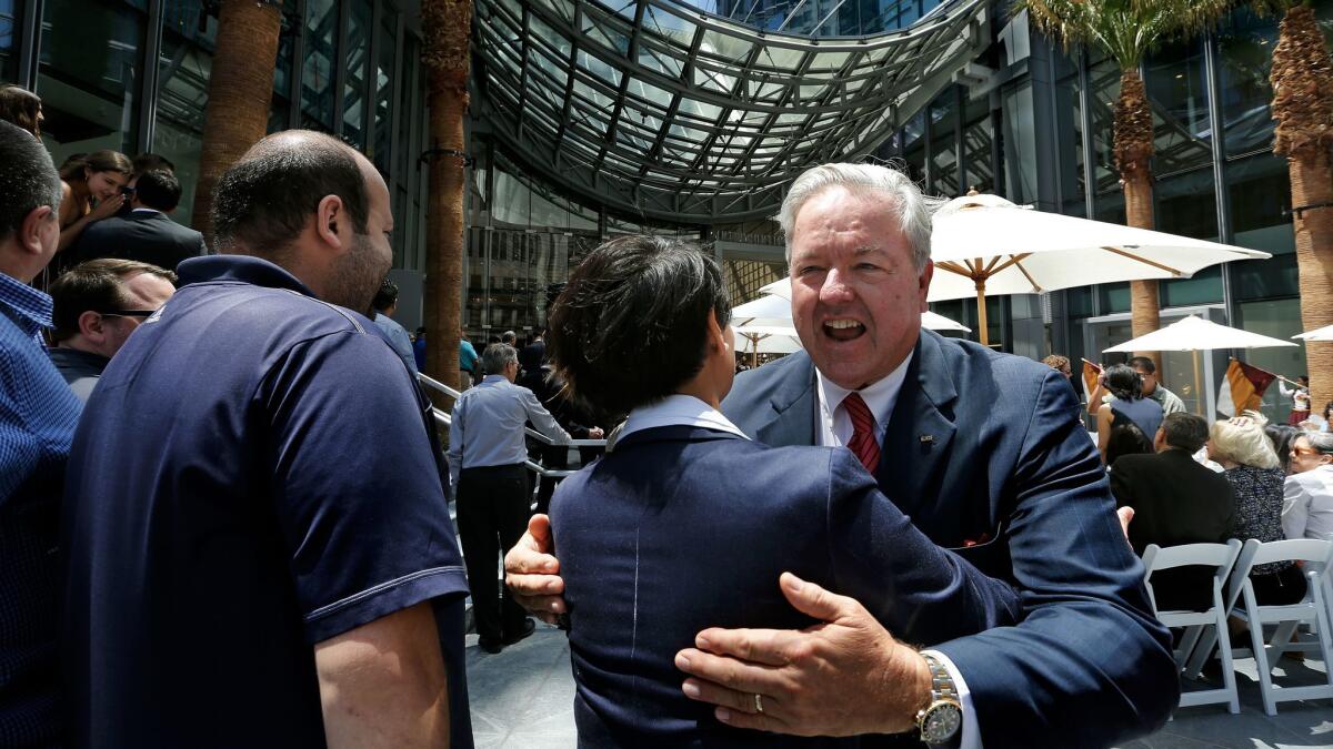 Christopher Martin, right, chairman and chief executive of AC Martin, celebrates with Blanca Diaz, senior projects engineer for Turner Construction Co., during the grand opening ceremony for the Wilshire Grand Center.