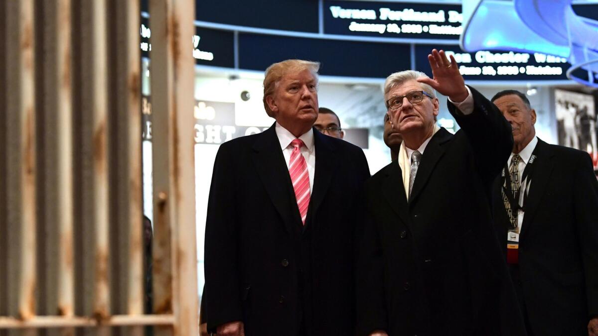 President Trump, left, listens as Mississippi Gov. Phil Bryant shows him the Hinds County Jail display at the Mississippi Civil Rights Museum in Jackson, Miss., on Saturday.