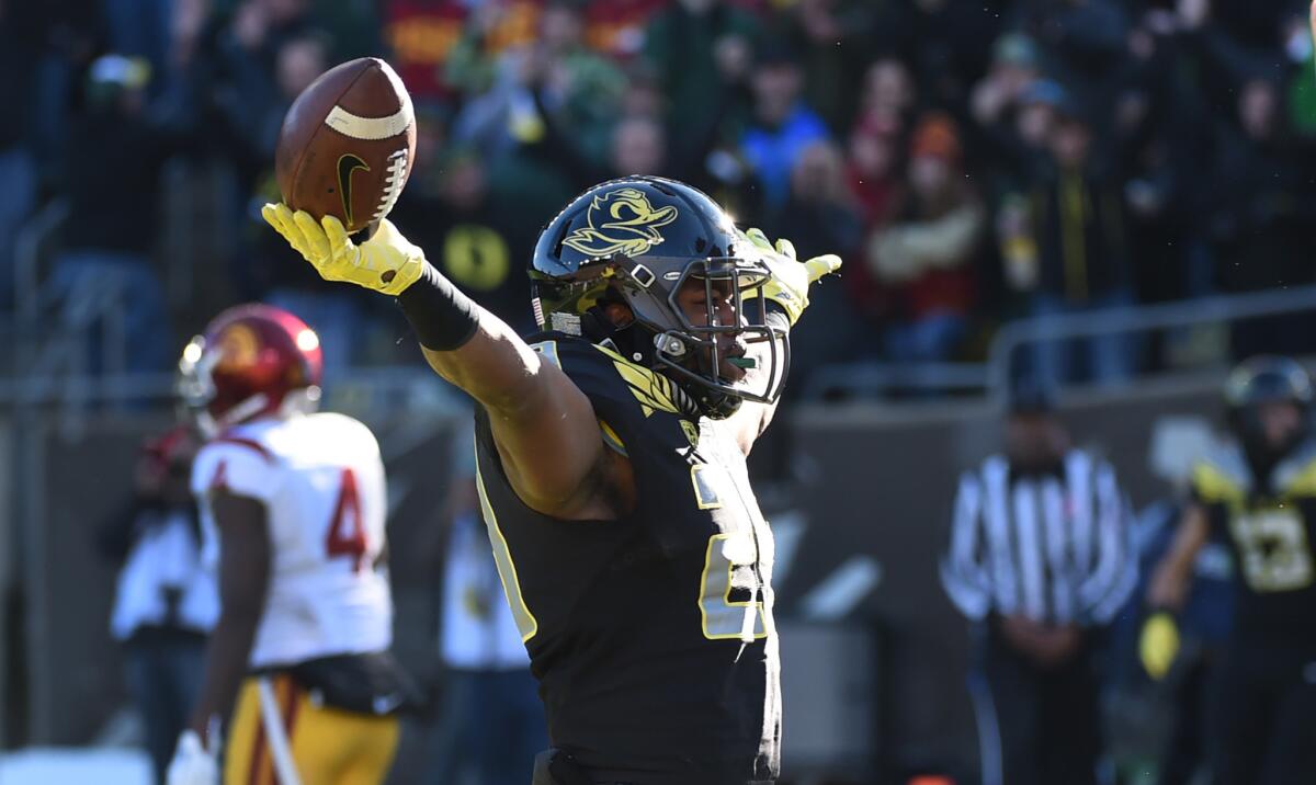 Oregon running back Kani Benoit celebrates after catching a touchdown pass against USC in the first half.