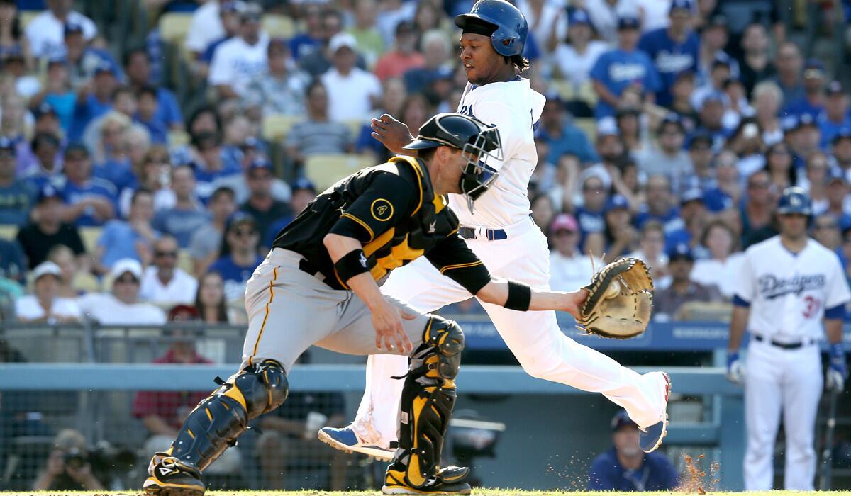 Dodgers shortstop Hanley Ramirez beats the throw to catcher Chris Stewart to score on a sacrifice fly by teammate Matt Kemp in the third inning Saturday evening at Dodger Stadium.