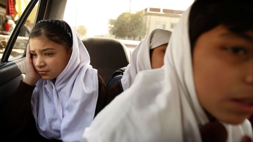 A girl is whisked by car from a shelter run by Women for Afghan Women to a nearby private school in Kabul in October 2009. Guards refuse entrance to unannounced guests, including husbands who bought the girls as brides.