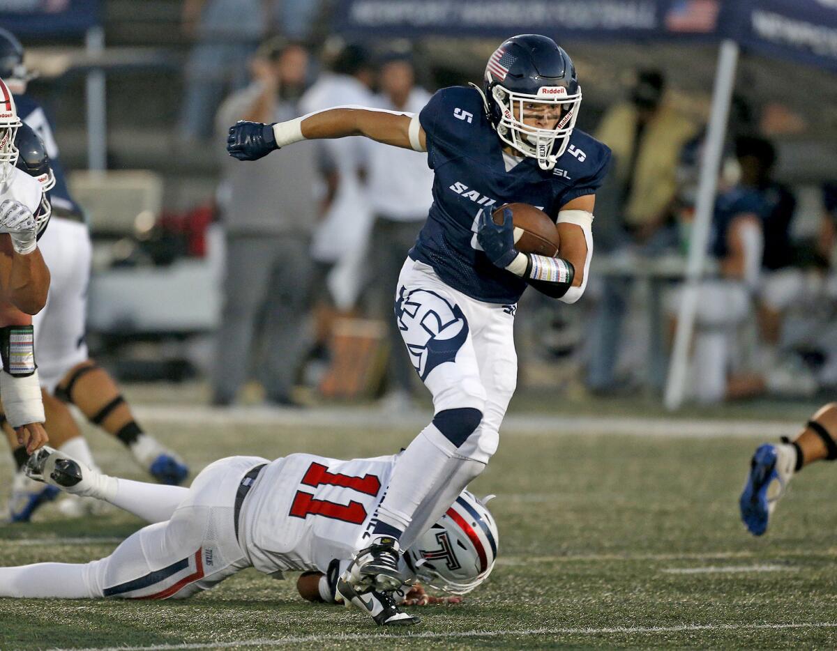 Newport Harbor running back Jagger Blauwkamp (5) eludes a tackle against Tesoro at Davidson Field on Thursday.