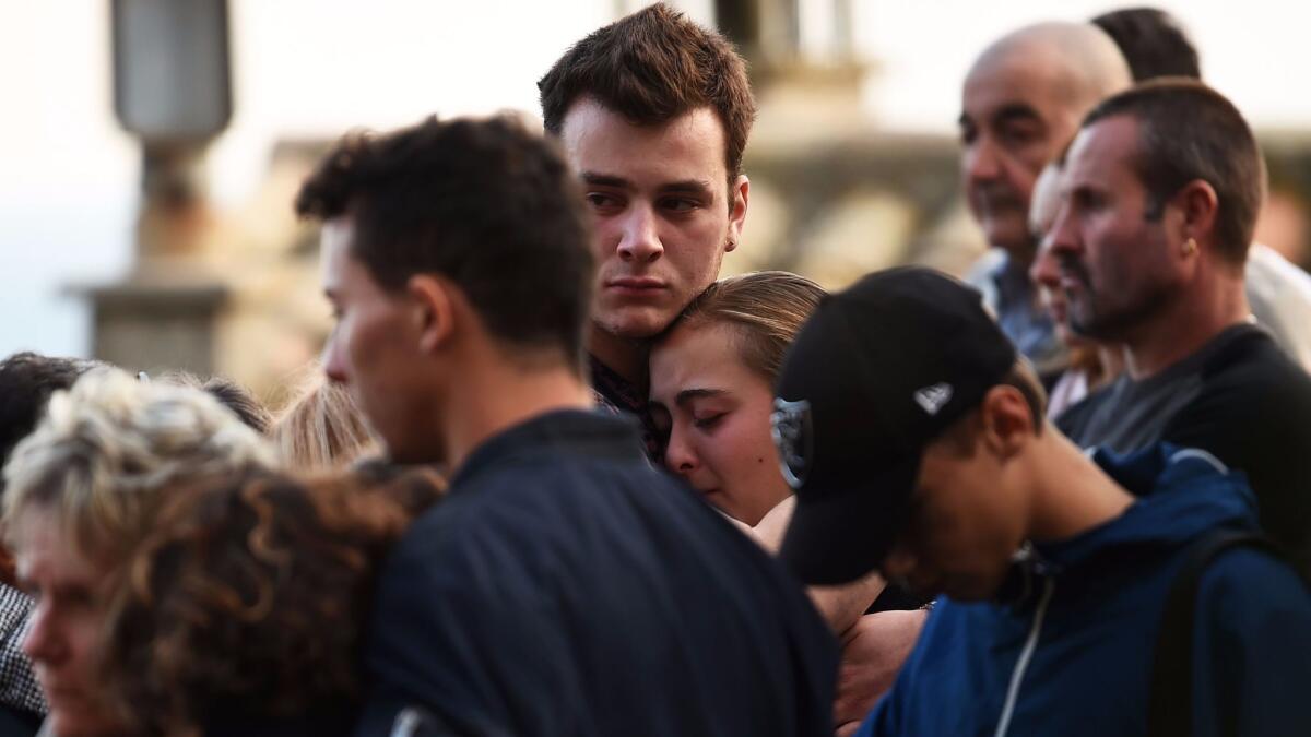 Relatives gather for a tribute in Eguilles, France, on Monday, the day after two cousins were fatally stabbed by an attacker in Marseilles.