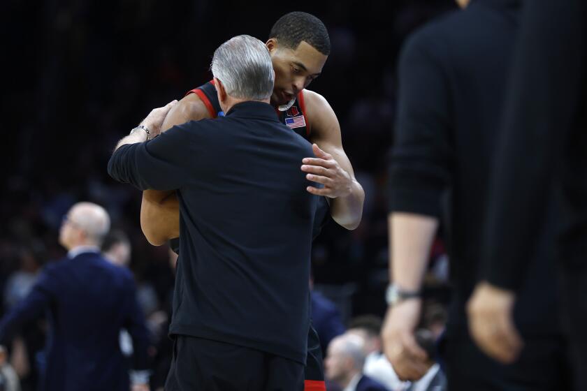 Boston, MA- March 28: San Diego State's Jaedon LeDee hugs coach Brian Dutcher after he came out of the game during the final moments of a loss to UConn during a NCAA Tournament Sweet 16 game at the TD Garden on Wednesday, March 28, 2024 in Boston, MA. (K.C. Alfred / The San Diego Union-Tribune)