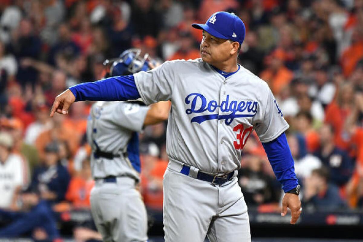 Dodgers manager Dave Roberts walks back to the dugout after visiting the mound. (Wally Skalij / Los Angeles Times)