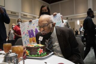 Leon Williams celebrates his 100th birthday with family, friends and Rotary Club members.