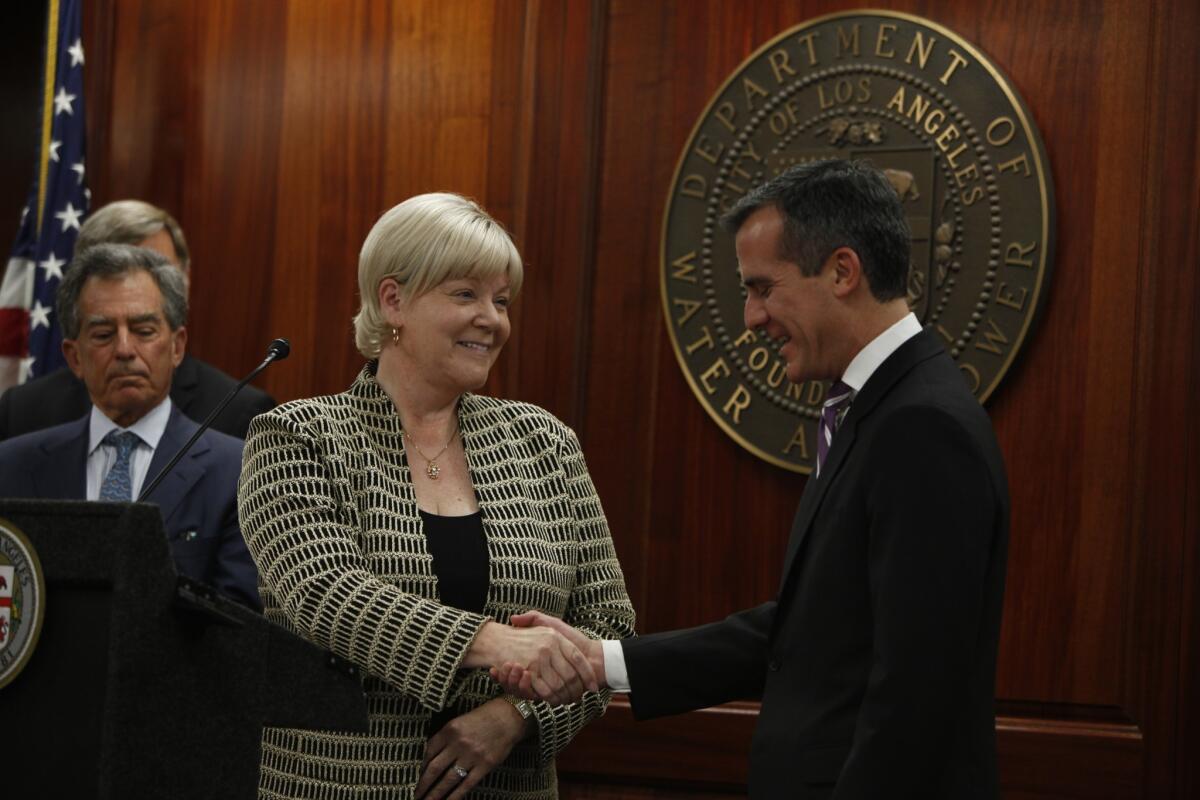 Los Angeles Mayor Eric Garcetti, right, introduces Marcie Edwards, left, his choice to lead the DWP at a press conference on January 30, 2014. Edwards takes over a department still struggling to speed up customer service response times.