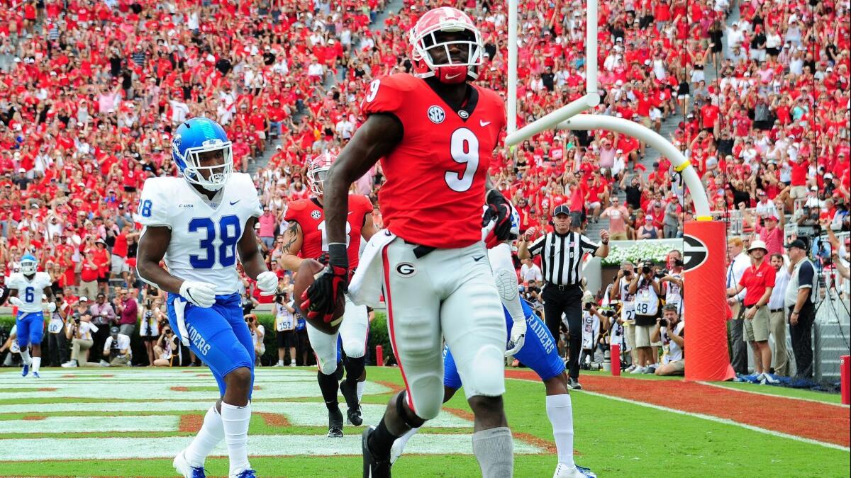 Georgia's Jeremiah Holloman makes a catch for a touchdown against Middle Tennessee on Saturday at Sanford Stadium in Athens, Ga.