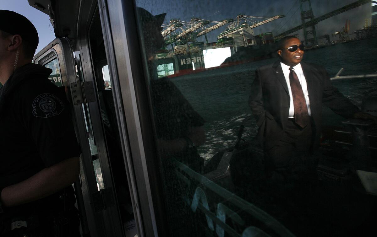 Reflected in the windshield of a Port Police boat, Los Angeles Port Police Chief Ronald Boyd rides through the harbor near the Vincent Thomas Bridge in 2011.