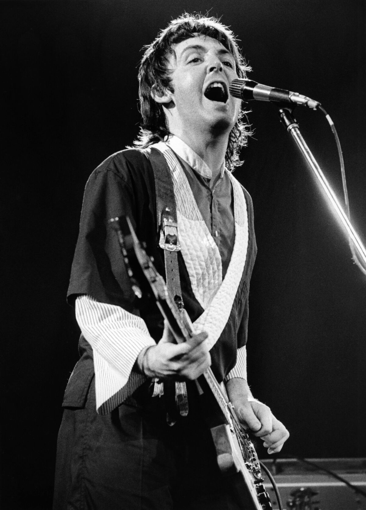 Paul McCartney plays bass as he performs with Wings.