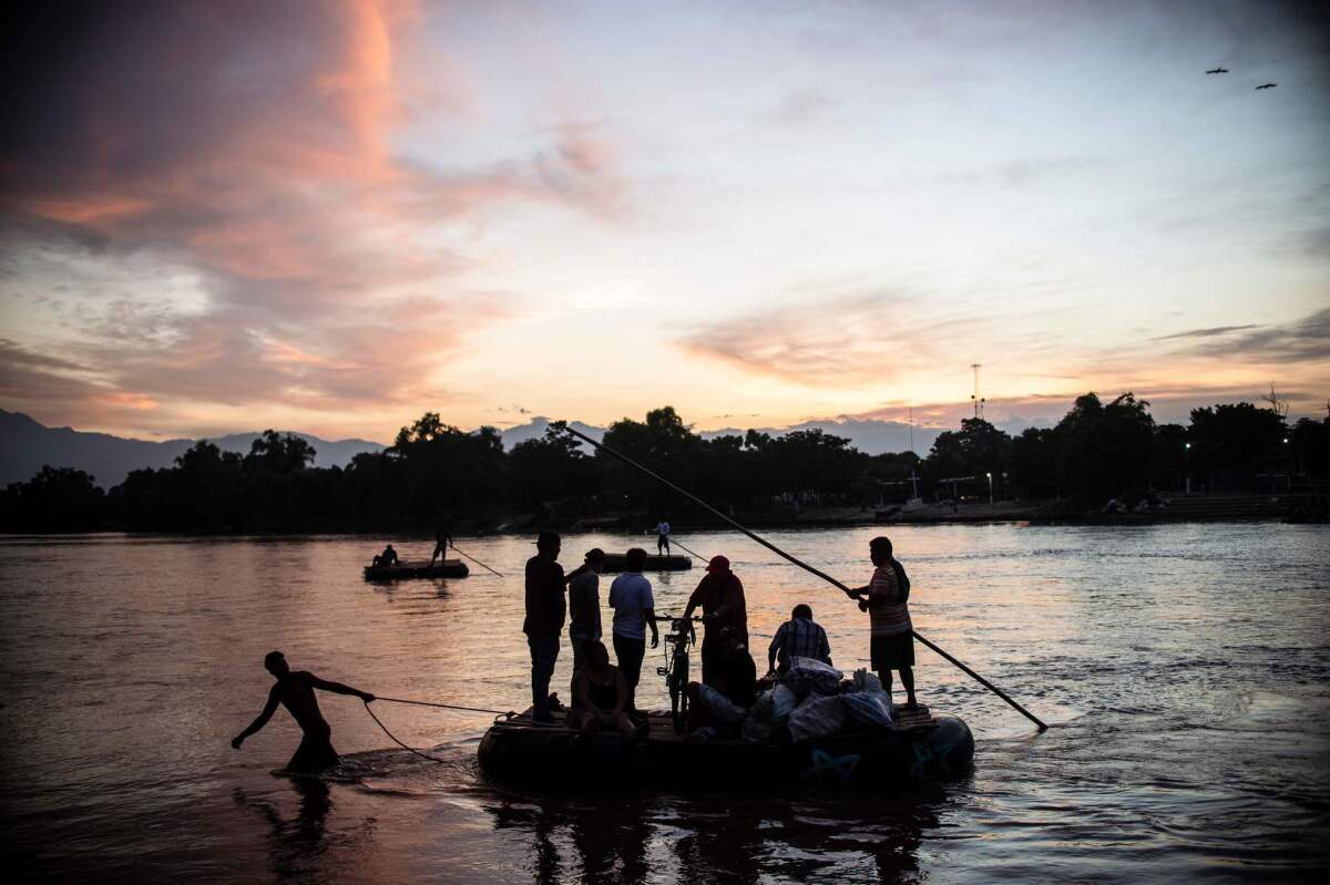 Migrants and residents use a makeshift raft to cross the Suchiate river between Mexico and Guatemala, at Ciudad Hidalgo, Mexico.