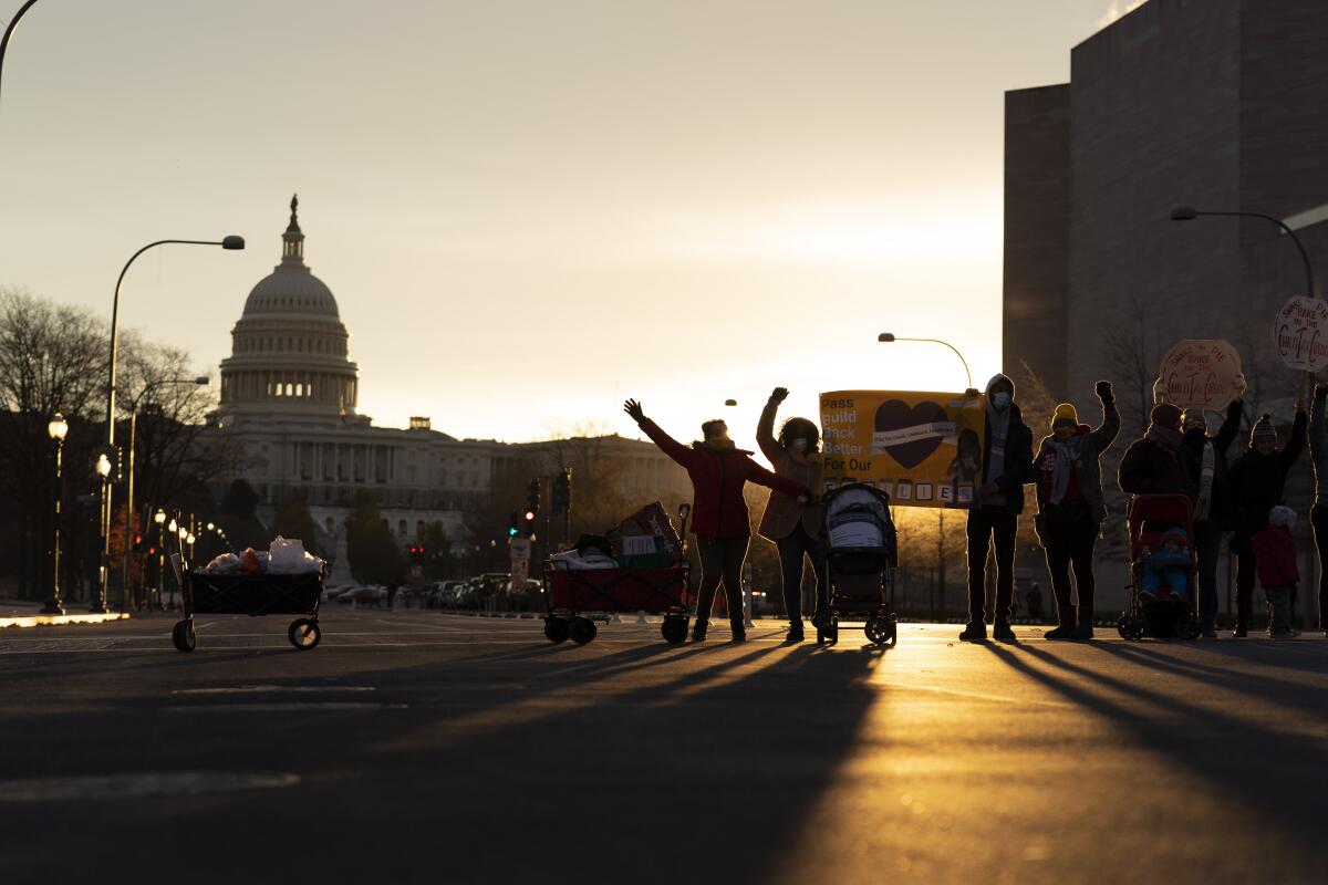 Demonstrators block Pennsylvania Avenue in Washington, D.C., during rush hour, with the Capitol in the background.