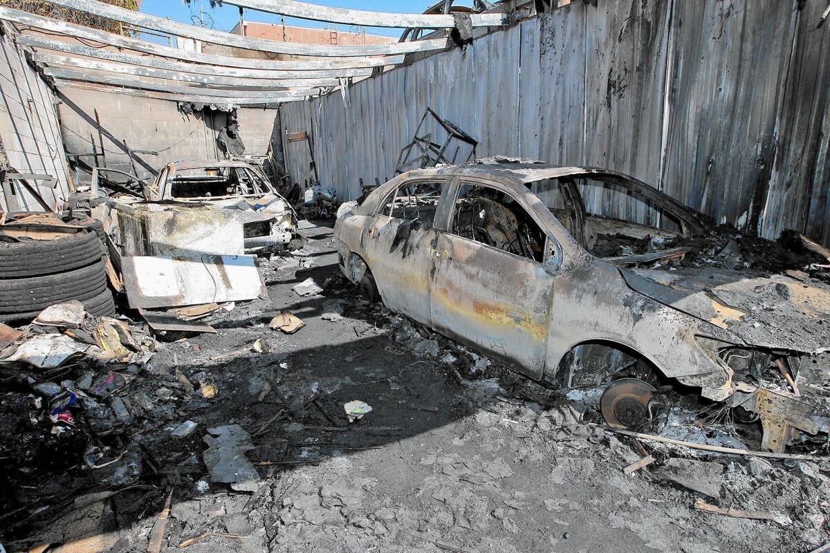 The remains of two cars sit in a garage destroyed in a suspected arson fire at Crescenta Valley Tow on Monday. Photographed on Wednesday, February 18, 2015.