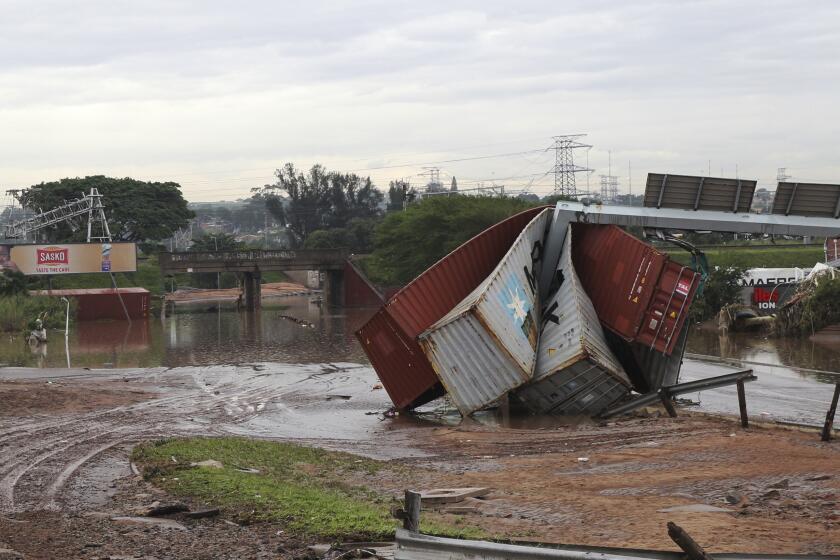 Shipping containers carried away and left in a jumbled pile by floods in Durban, South Africa, Wednesday, April 13, 2022. Flooding in South Africa's Durban area has taken at least 259 lives and is a "catastrophe of enormous proportions," President Cyril Ramaphosa said Wednesday. (AP Photo/Str)