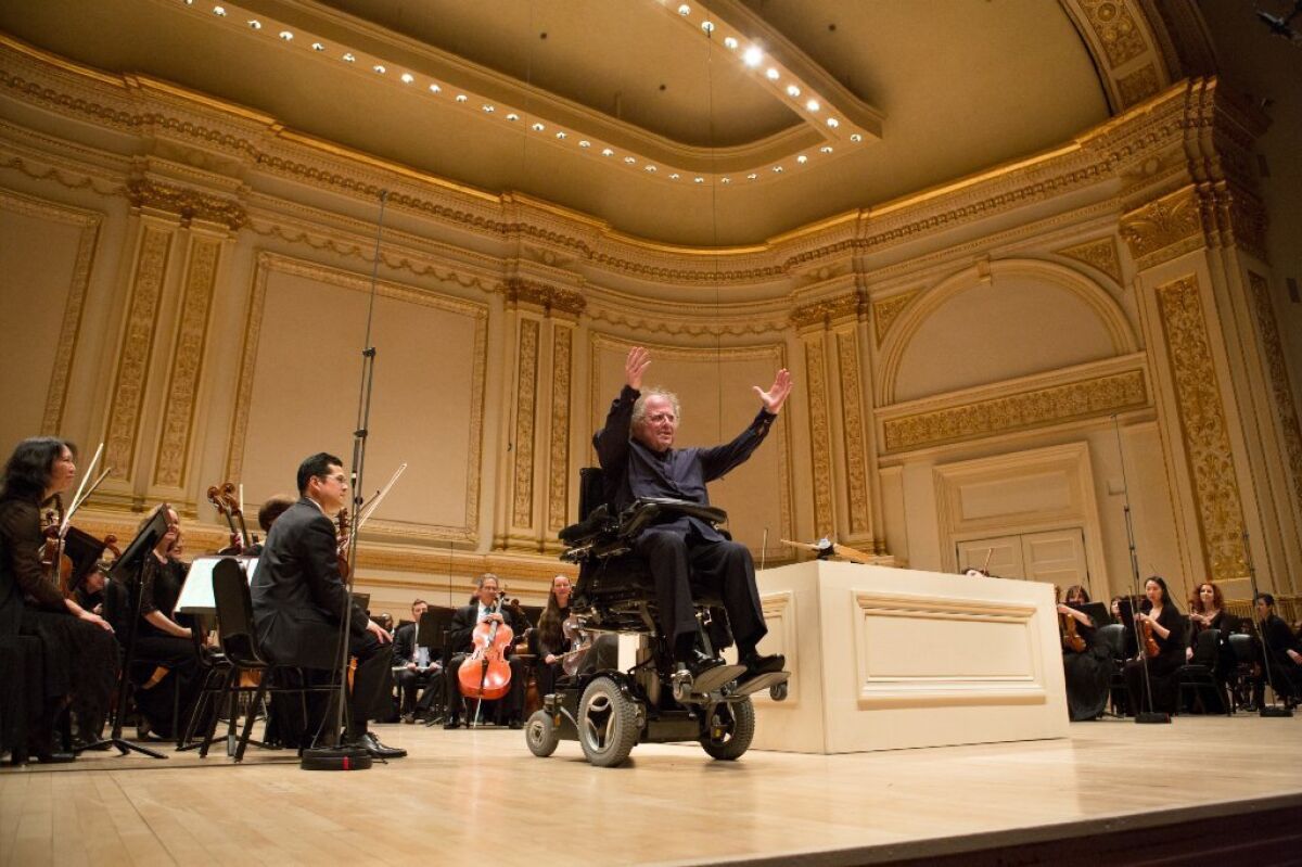 Conductor James Levine, with members of the Metropolitan Opera orchestra, at a concert at Carnegie Hall in New York.
