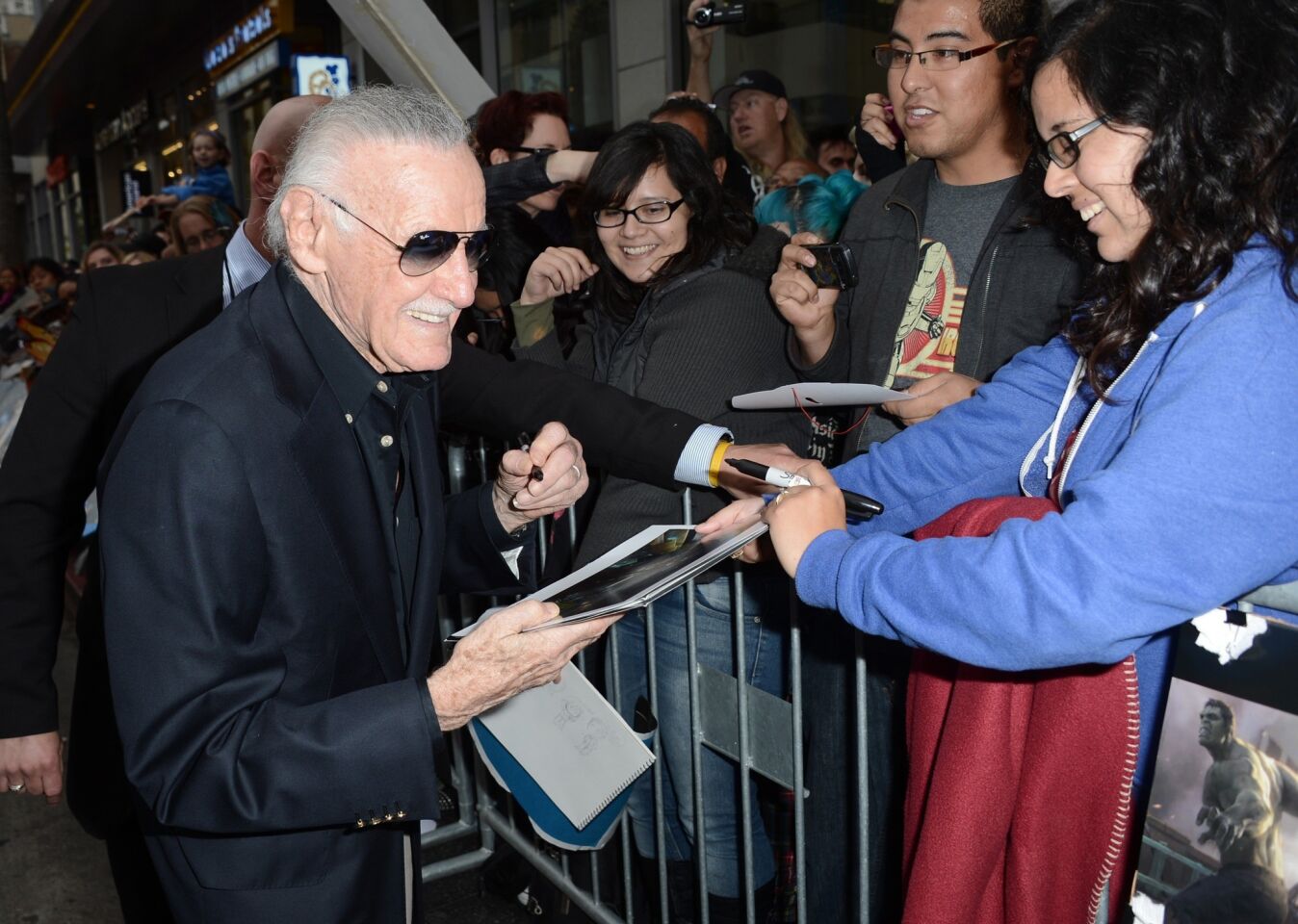 Stan Lee stops to sign autographs.