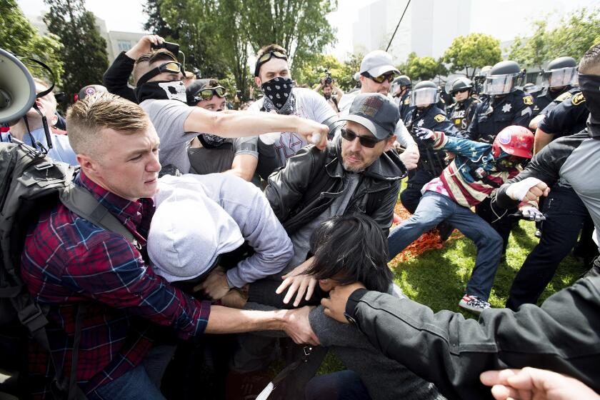 Protesters for and against President Donald Trump brawl, April 15, 2017, in Berkeley, Calif. For the second time in five years, federal charges against alleged members of a violent white supremacist group accused of inciting violence at California political rallies were dismissed by a judge Wednesday, Feb. 21, 2024, who found they were selectively prosecuted. (AP Photo/Noah Berger)