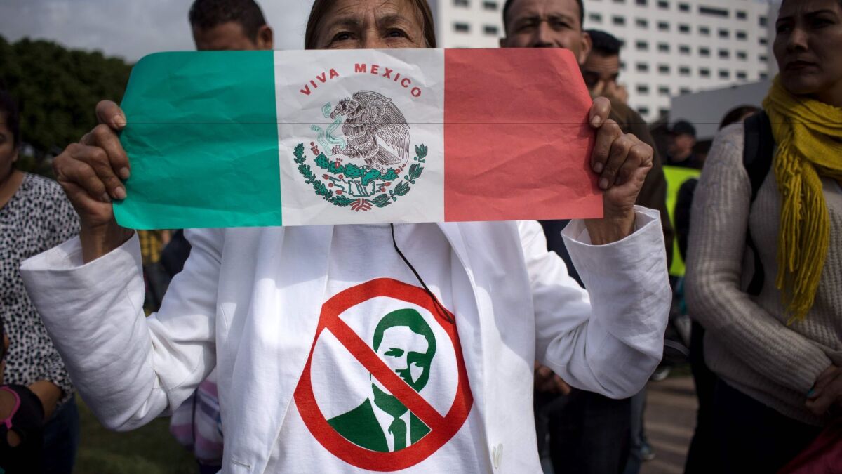 A protester in Tijuana shows her feelings about President Enrique Peña Nieto, whose image appears on her shirt.