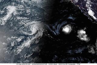 This satellite image provided by the National Oceanic and Atmospheric Administration (NOAA) shows Tropical Storm Hone and Hurricane Gilma located southeast of Hawaii, Friday, Aug. 22, 2024. (NOAA via AP)