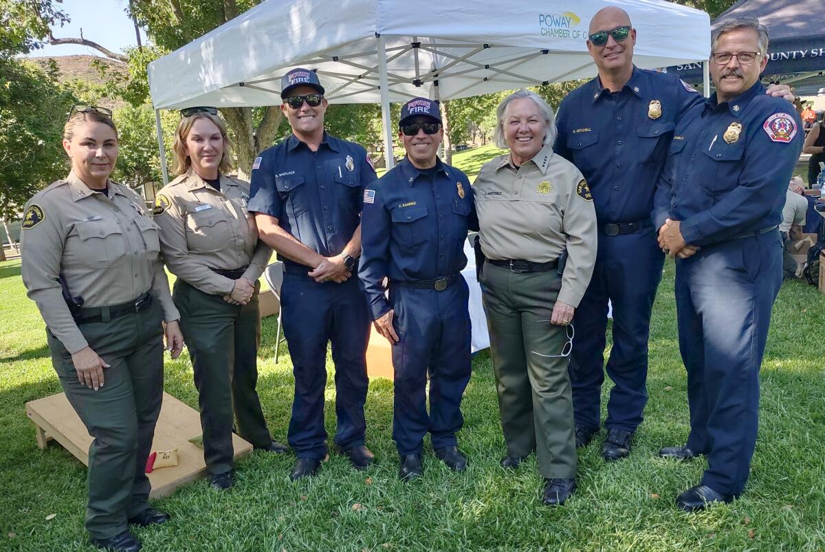 San Diego County Sheriff Kelly Martinez, third from right, mingles with deputies and firefighters at National Night Out.