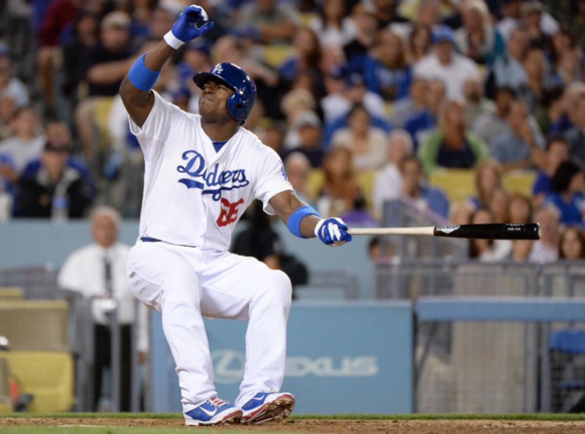 Dodgers right fielder Yasiel Puig stumbles after fouling a ball off his left foot in the fifth inning Friday night at Dodger Stadium.