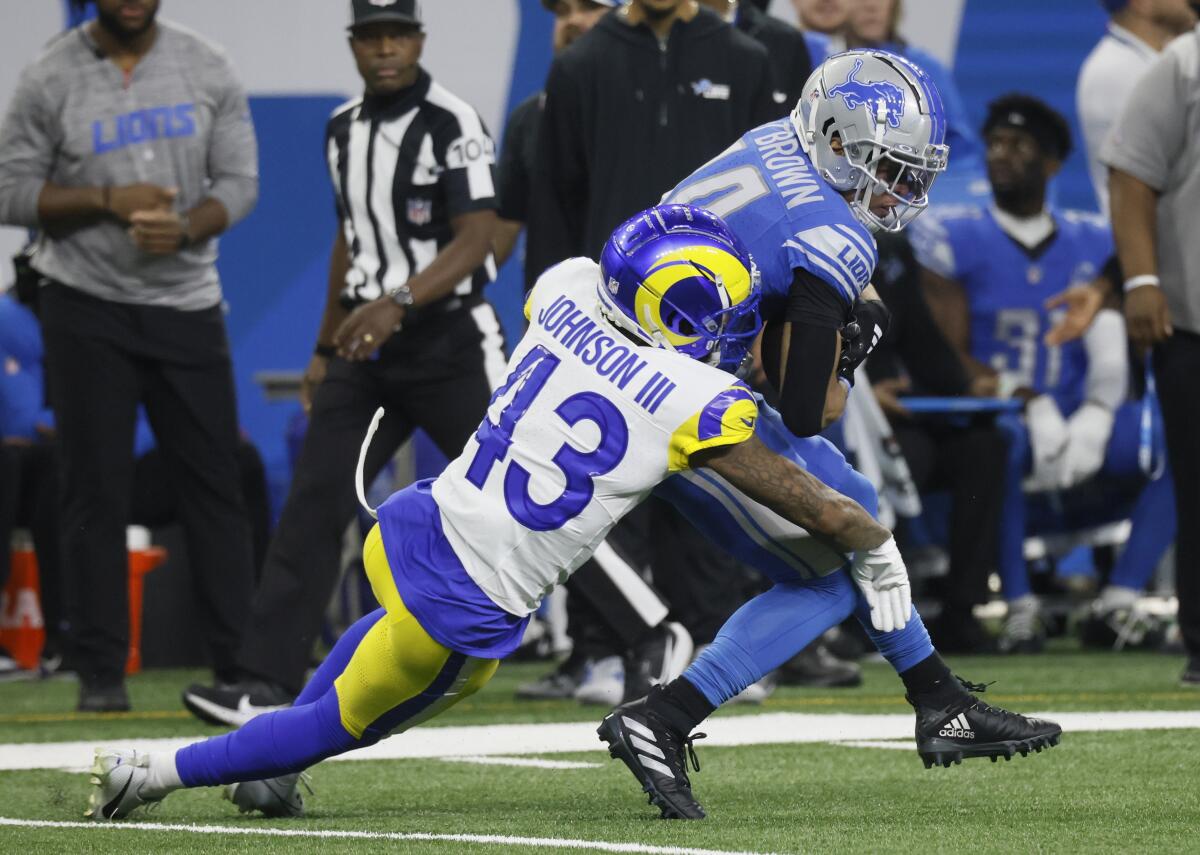 Rams safety John Johnson III tackles  Lions wide receiver Amon-Ra St. Brown in their season opener. 