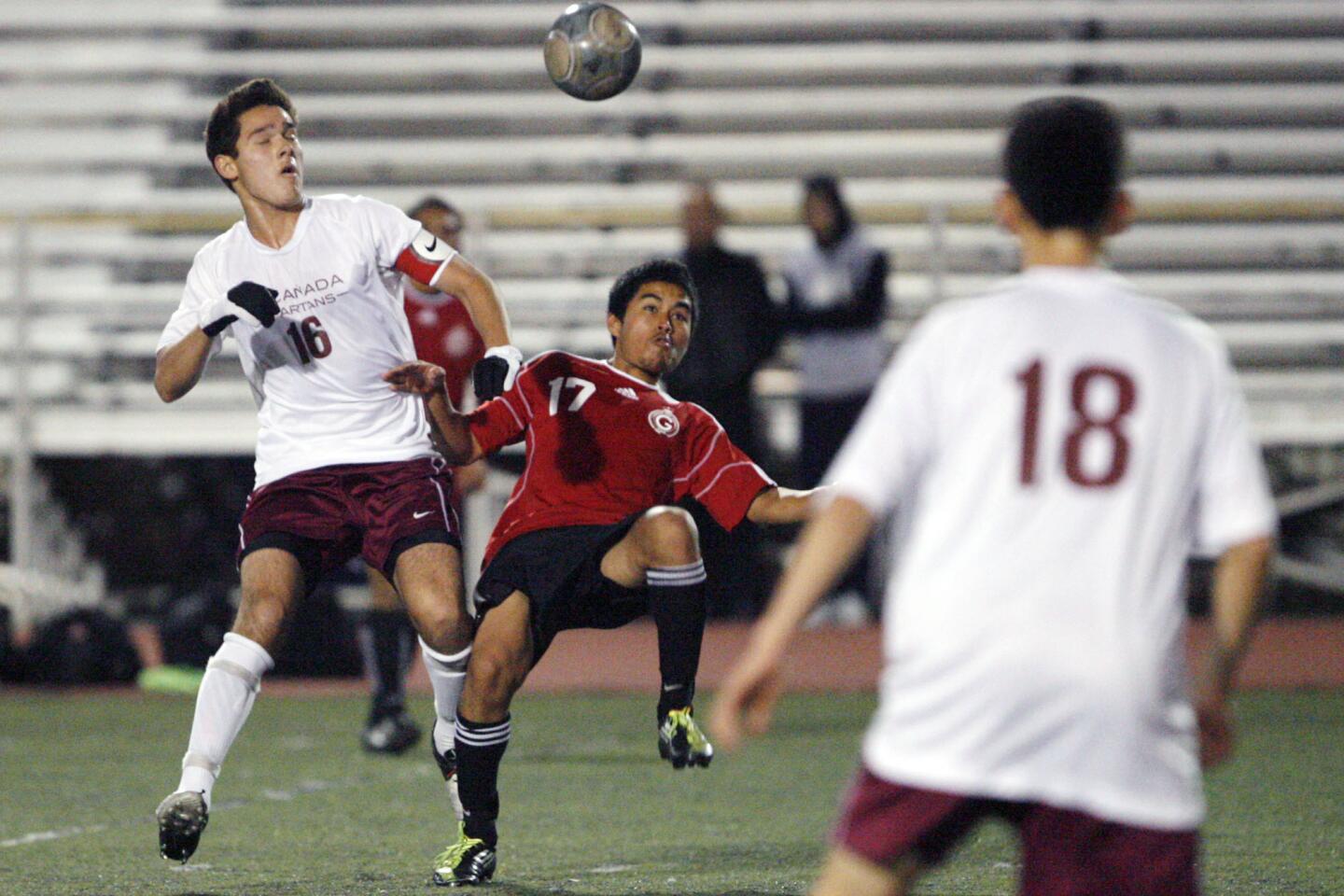La Canada's Aidan Tourani, left, and Glendale's Albert Chamagua fight for the ball during a game at La Canada High School on Friday, December 28, 2012.