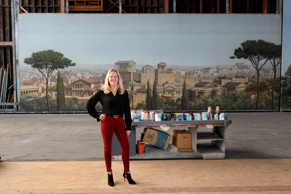 Lynne Coakley, president of JC Backings, with the "Ben-Hur" (1959) movie backdrop in the Scenic Art building at Sony Pictures Studios in Culver City.