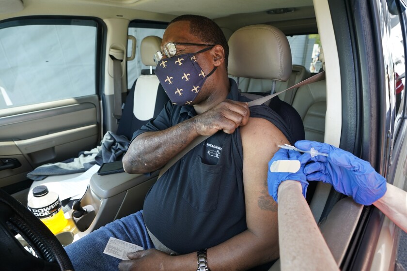 Brian Snipes receives a drive-thru vaccination
