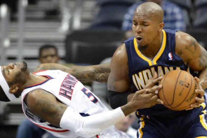 Pacers power forward David West drives against Hawks power forward Josh Smith during a game at Philips Arena in Atlanta.